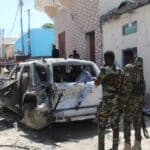 Troops look at a car bomb blast scene in Mogadishu, Somalia, January 2022. Photo: AFP/Getty Images.