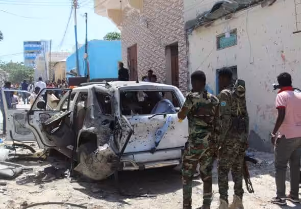 Troops look at a car bomb blast scene in Mogadishu, Somalia, January 2022. Photo: AFP/Getty Images.