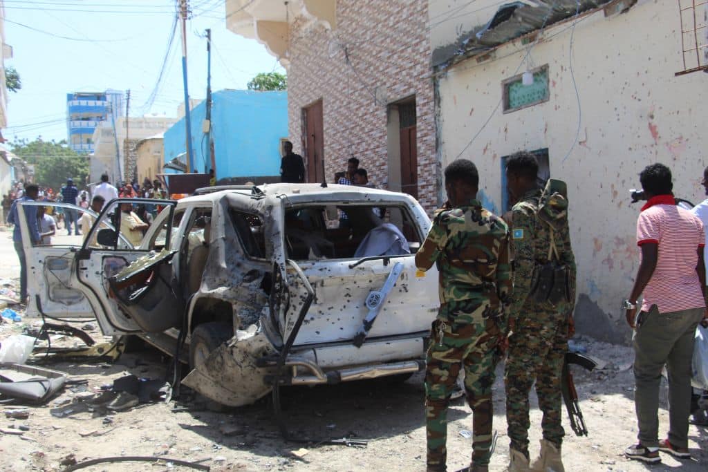Troops look at a car bomb blast scene in Mogadishu, Somalia, January 2022. Photo: AFP/Getty Images.