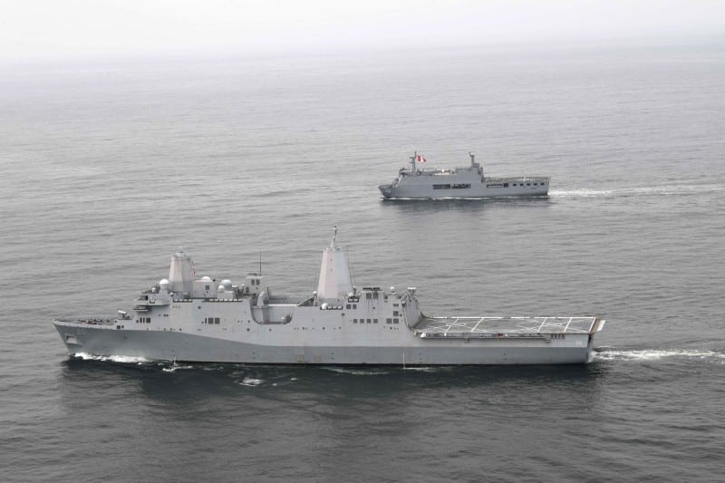 The amphibious transport dock ship USS John P. Murtha (foreground) and Peruvian navy Makassar-class landing platform dock ship BAP Pisco (background) conduct tactical maneuvers and naval formations during a training exercise in the Pacific Ocean. Photo: James Ho/US Navy/Wikimedia Commons.