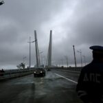 A police officer stands guard on a cable-braced bridge that connects Russky Island and Vladivostok in the city of Russian Far Eastern part of Vladivostok, Russia, Wednesday, Sept 5, 2012. Photo: AP.