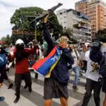 Opponents show a shotgun they snatched from police during a demonstration in Caracas, May 3, 2017. Photo: Carlos García Rawlins/Reuters.