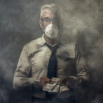 Business executive wearing a mask and holding cash banknotes. Photo: Getty Images.