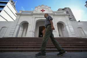 Man walking in front of the Venezuelan Red Cross headquarters in Caracas, on August 6, 2023. Photo: AFP.