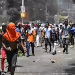 People march as tires burn during a protest against insecurity near the prime minister official residence in Port-au-Prince, Haiti, August 7, 2023. Photo: AFP.