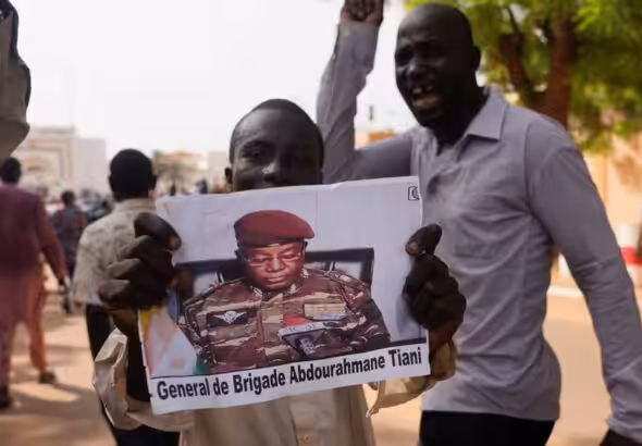 Nigeriens participate in a march called by supporters of coup leader Gen. Abdourahmane Tchiani, pictured, in Niamey, Niger, on July 30. Photo: Sam Mednick/Associated Press.