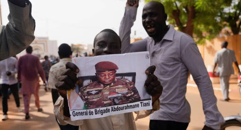 Nigeriens participate in a march called by supporters of coup leader Gen. Abdourahmane Tchiani, pictured, in Niamey, Niger, on July 30. Photo: Sam Mednick/Associated Press.