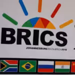 A delegate walks past a BRICS logo ahead of the 10th BRICS Summit, in Sandton, South Africa, July 24, 2018. Photo: Reuters.
