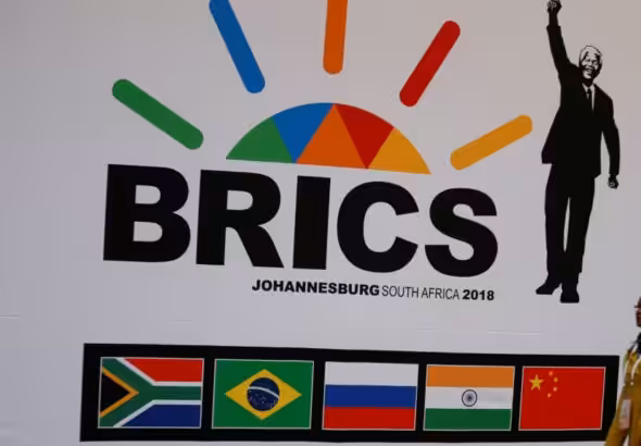 A delegate walks past a BRICS logo ahead of the 10th BRICS Summit, in Sandton, South Africa, July 24, 2018. Photo: Reuters.