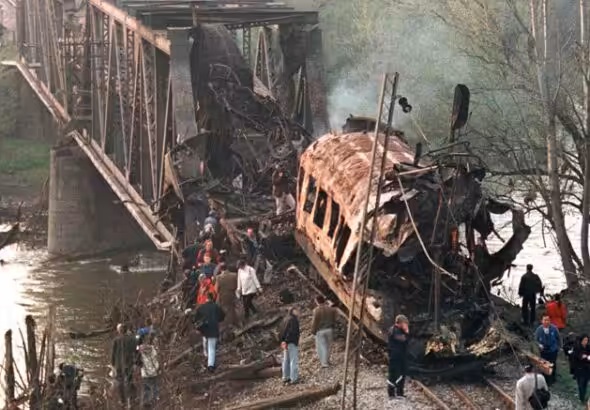 The smoldering wreckage of a passenger train after being hit by two missiles launched from a NATO F-15. At least 55 commuters were killed. Photo: Struggle La Lucha/File photo.