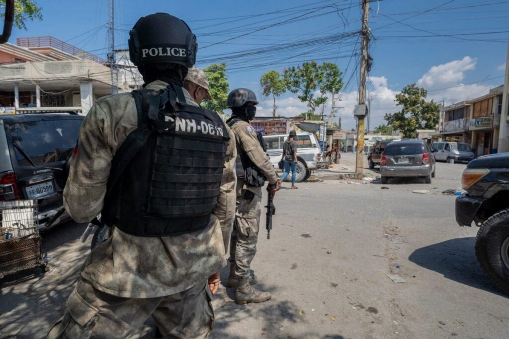 Police officers patrol a street in the Haitian capital of Port-au-Prince. Photo: Marvens Compère/Haitian Times.