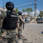 Police officers patrol a street in the Haitian capital of Port-au-Prince. Photo: Marvens Compère/Haitian Times.