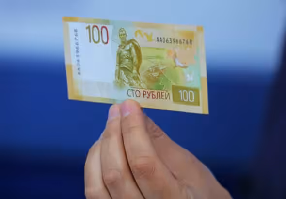 Hand holding a Russian Ruble bill. Photo: Reuters.