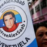 Woman in a demonstration holding a banner with Alex Saab's face and a #FreeAlexSaab slogan. Photo: RedRadioVE/File photo.