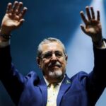 Guatemalan President-elect Bernardo Arévalo raising his hands at a political rally. Photo: Cristina Chiquin/Reuters/File photo.