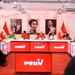 Cabello and PSUV members seated in front of portraits of Simón Bolívar and Hugo Chávez. File photo.