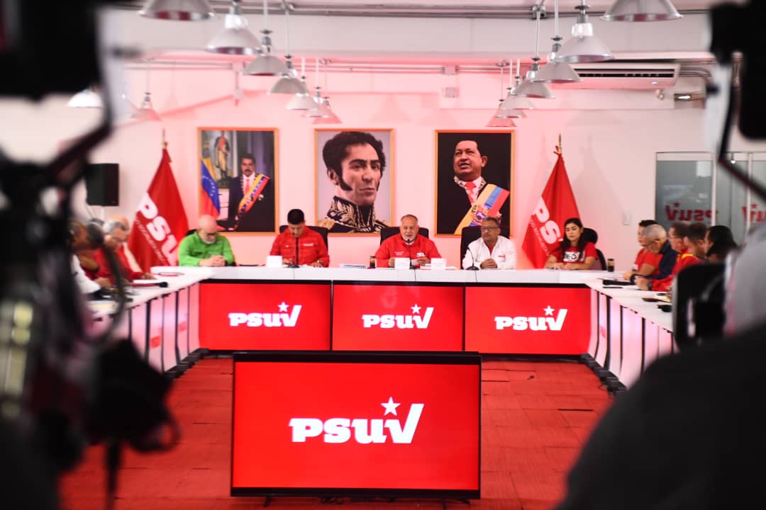 Cabello and PSUV members seated in front of portraits of Simón Bolívar and Hugo Chávez. File photo.