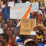 Protesters in Niger hold signs in support of the CNSP and against France. Photo: Peoples Dispatch/file photo.