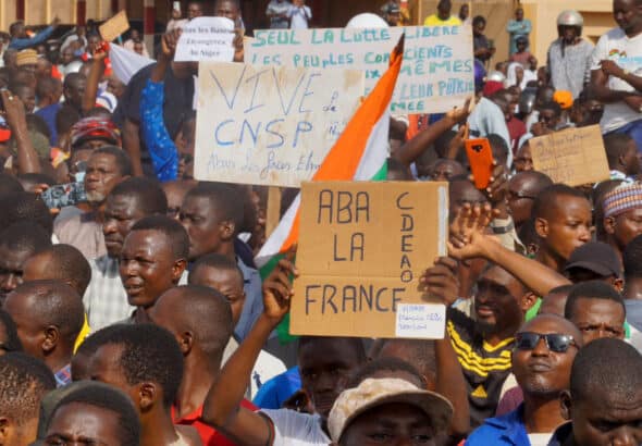 Protesters in Niger hold signs in support of the CNSP and against France. Photo: Peoples Dispatch/file photo.