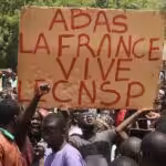 Protesters with sign that reads: Down with France, long live the CNSP (National Council for the Safeguard of the Homeland). Photo: News Click/File photo.