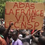 Protesters with sign that reads: Down with France, long live the CNSP (National Council for the Safeguard of the Homeland). Photo: News Click/File photo.