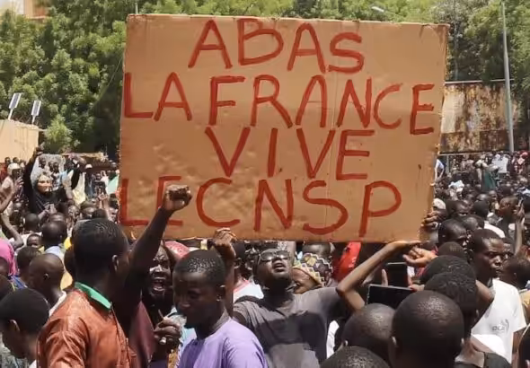 Protesters with sign that reads: Down with France, long live the CNSP (National Council for the Safeguard of the Homeland). Photo: News Click/File photo.