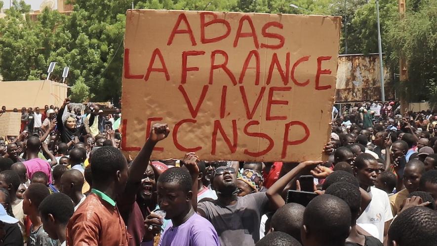 Protesters with sign that reads: Down with France, long live the CNSP (National Council for the Safeguard of the Homeland). Photo: News Click/File photo.