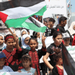 A group of children and teenagers hold a vigil at the Gaza port, demanding an end to the Israeli siege. Photo: Mahmoud Ajjour, The Palestine Chronicle.