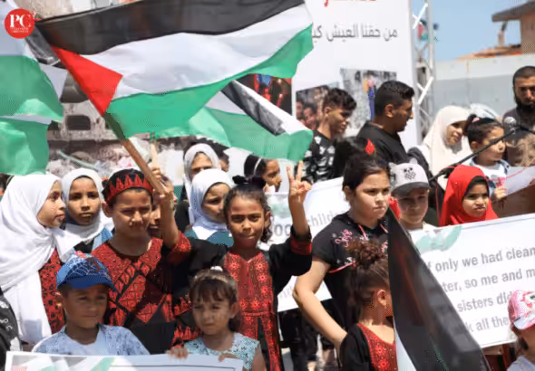 A group of children and teenagers hold a vigil at the Gaza port, demanding an end to the Israeli siege. Photo: Mahmoud Ajjour, The Palestine Chronicle.