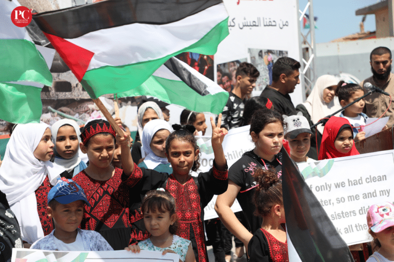 A group of children and teenagers hold a vigil at the Gaza port, demanding an end to the Israeli siege. Photo: Mahmoud Ajjour, The Palestine Chronicle.