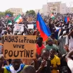 Protesters in favor of the military junta, some holding anti-France, pro-Russia signs, in Niamey, Niger, 3 August 2023. Photo: Sam Mednick/AP Photo.