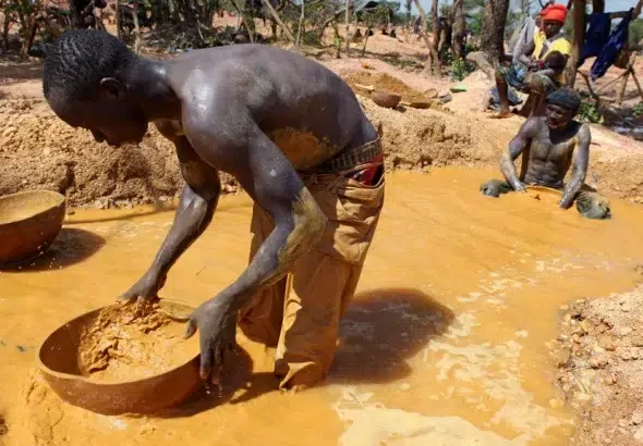 A gold miner pans for gold in Koflatie, Mali, on October 28, 2014, a mine located a few miles from the border with its southwestern neighbor Guinea. Photo: Sebastien Rieussec/AFP.