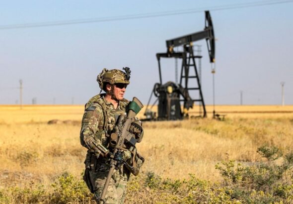 A US occupation soldier patrols near an oil well in al-Qahtaniyah in Syria's northeastern Hasakah province, June 14, 2023. Photo: AFP.