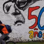 A man pedals his bicycle past a mural marking the 50th anniversary of the country's military coup, with a reminder of those disappeared during the Augusto Pinochet regime and an image depicting the deposed President Salvador Allende, in Santiago, Chile, Friday, September 8, 2023. Photo: Morning Star/File photo.