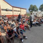Tocorón Prison inmates seated on the ground while being guarded by law enforcement agents. Photo: X/@NicolásMaduro.