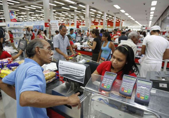 Person paying at a crowded grocery store in Venezuela. File photo.