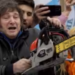 Argentinian far-right presidential candidate Javier Milei carries a chainsaw during a campaign rally in La Plata, Argentina, September 12, 2023. Photo: Natacha Pisarenko/AP.