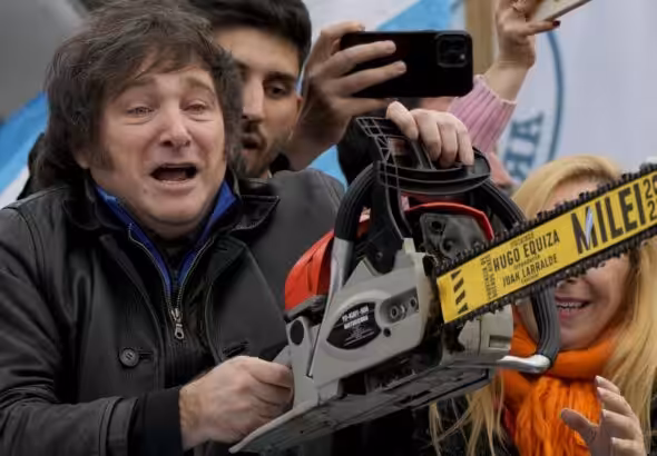 Argentinian far-right presidential candidate Javier Milei carries a chainsaw during a campaign rally in La Plata, Argentina, September 12, 2023. Photo: Natacha Pisarenko/AP.