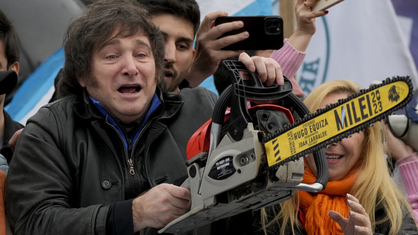 Argentinian far-right presidential candidate Javier Milei carries a chainsaw during a campaign rally in La Plata, Argentina, September 12, 2023. Photo: Natacha Pisarenko/AP.