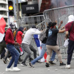 Protesters clash with police during demonstrations against the controversial mining contract with a subsidiary of a Canadian company, in Panama City, Panama. Photo: Welcome Velasco/EFE.