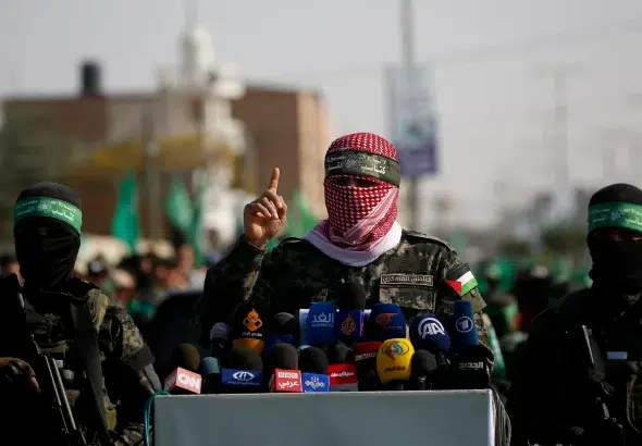 A spokesman for the Al-Qassam Brigades talks to the press in the town of Khan Younis, southern Gaza Strip, November 11, 2019. Photo: AP/Hatem Moussa.