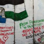 A mural on a wall depicting a person holding a Palestinian flag (left) and the following caption (right): “From Ferguson to Palestine, Resistance is not a crime, end racism now!” Photo: Sotwe.com/File photo.