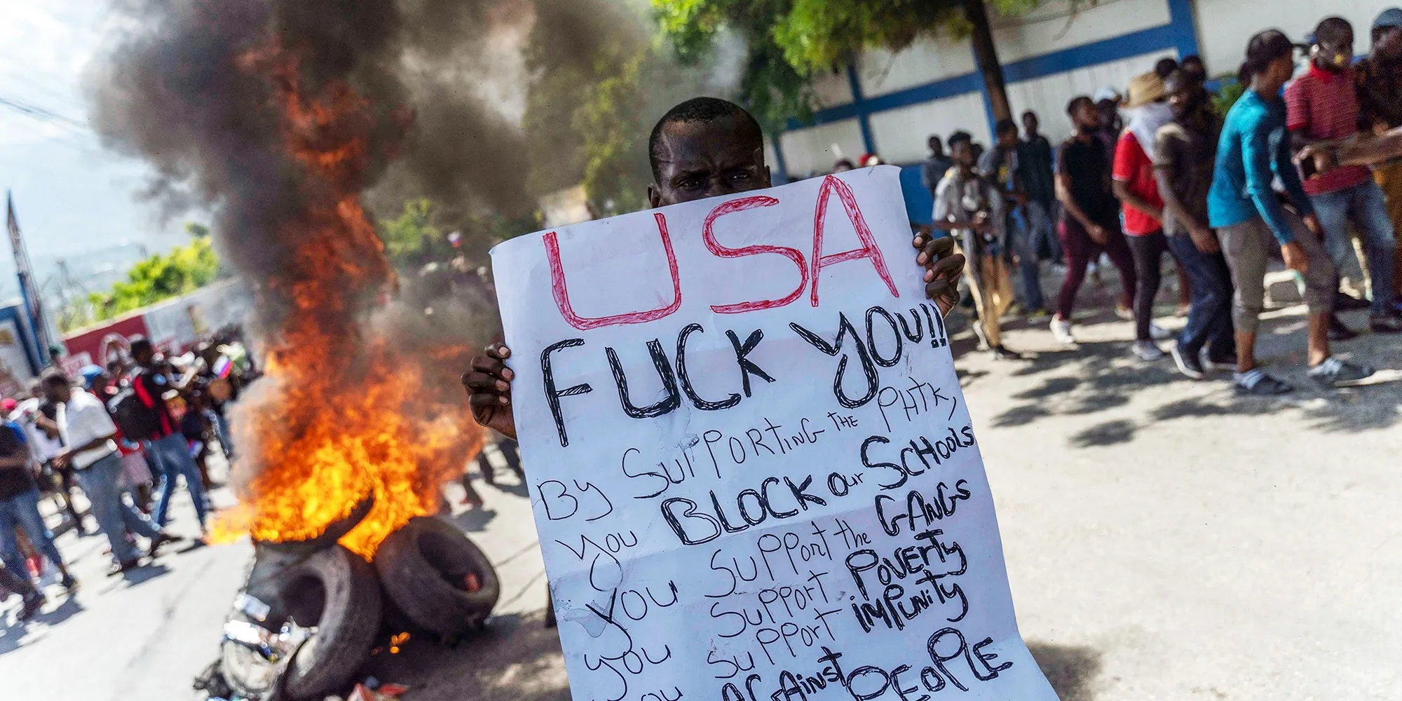 Haitian protester holds an anti-US sign during a protest against the unelected, US-backed Haitian regime, in Port-au-Prince, Haiti, on Oct. 17, 2022. Photo: Richard Pierrin/AFP.