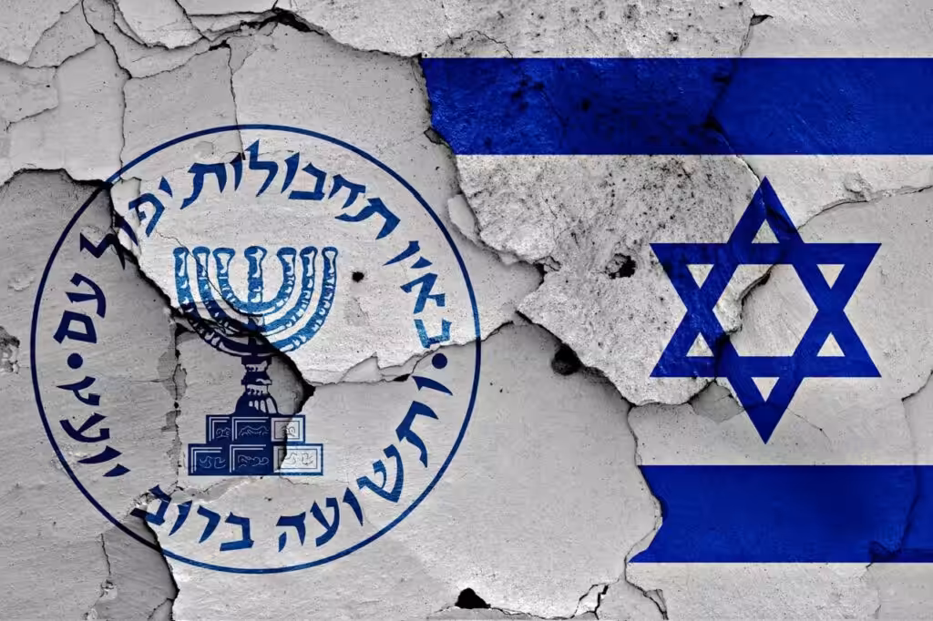 Logo of the Israeli intelligence agency Mossad and the Israeli flag painted on a cracked wall. Photo: Shutterstock.