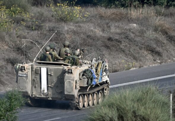 Israeli soldiers ride an armored vehicle along a road on the outskirts of the Gaza strip in occupied Palestine on October 28th. Photo: Aris Messinis/AFP.
