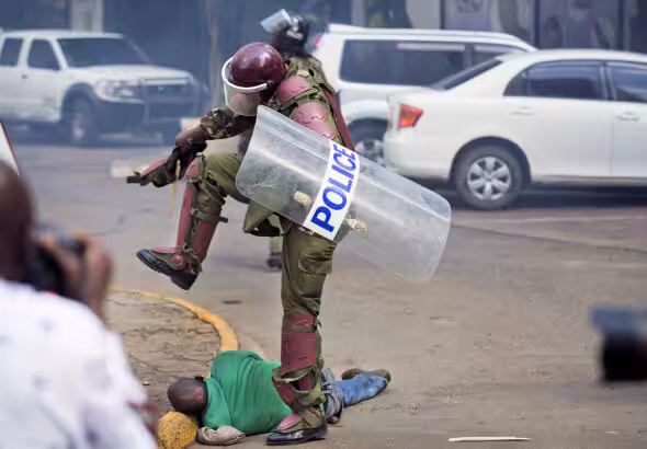 A Kenyan policeman stomping on a prone demonstrator in Nairobi in 2016. Credit: Ben Curtis/AP Photo.
