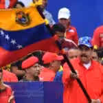 Venezuelan President Nicolás Maduro flies the national flag, accompanied by supporters. File photo.