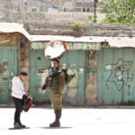 Photograph of an IDF soldier frisking a Palestinian child. Photo: Trocaire/Ireland.