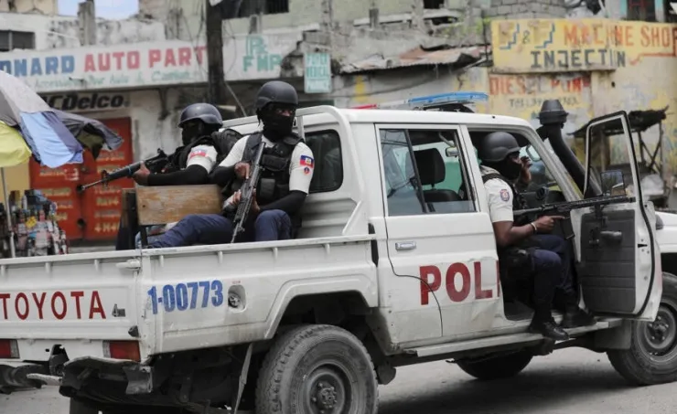 Police officers patrol a neighborhood amid an uptick in violence in downtown Port-au-Prince, Haiti, on April 25. Photo: Richard Pierrin/Getty Images.
