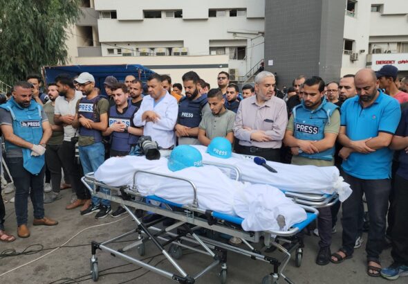 Journalists holding a funeral for their colleagues Mohammad Soboh and Saeed Al-Taweel, who were brutally killed after being targeted by an Israeli airstrike three nights ago while covering the evacuation of a building threatened by Israeli bombing west of Gaza City. Photo: Mahmoud Ajjour/The Palestine Chronicle.